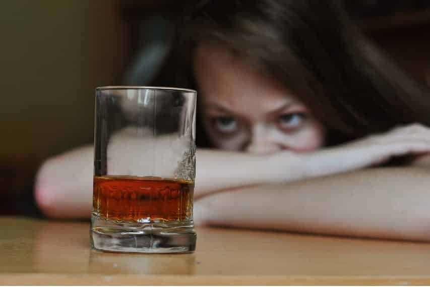 Woman staring at alcohol