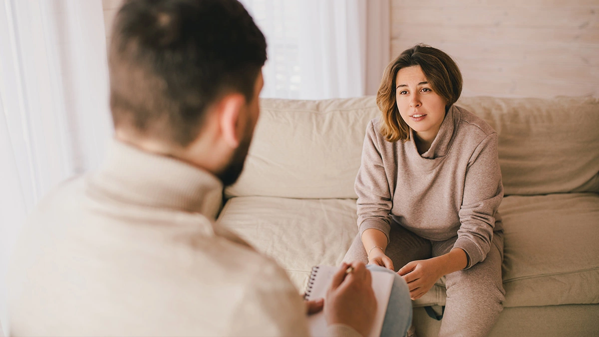 Woman on a therapist’s couch. Text explains choosing the right professional can make the biggest difference when faced with mental illness