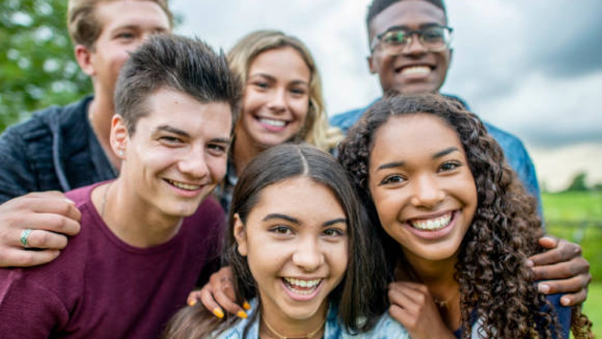 Group of teens smiling. Addiction can have a severe impact on adolescents, impacting their physical and mental health.