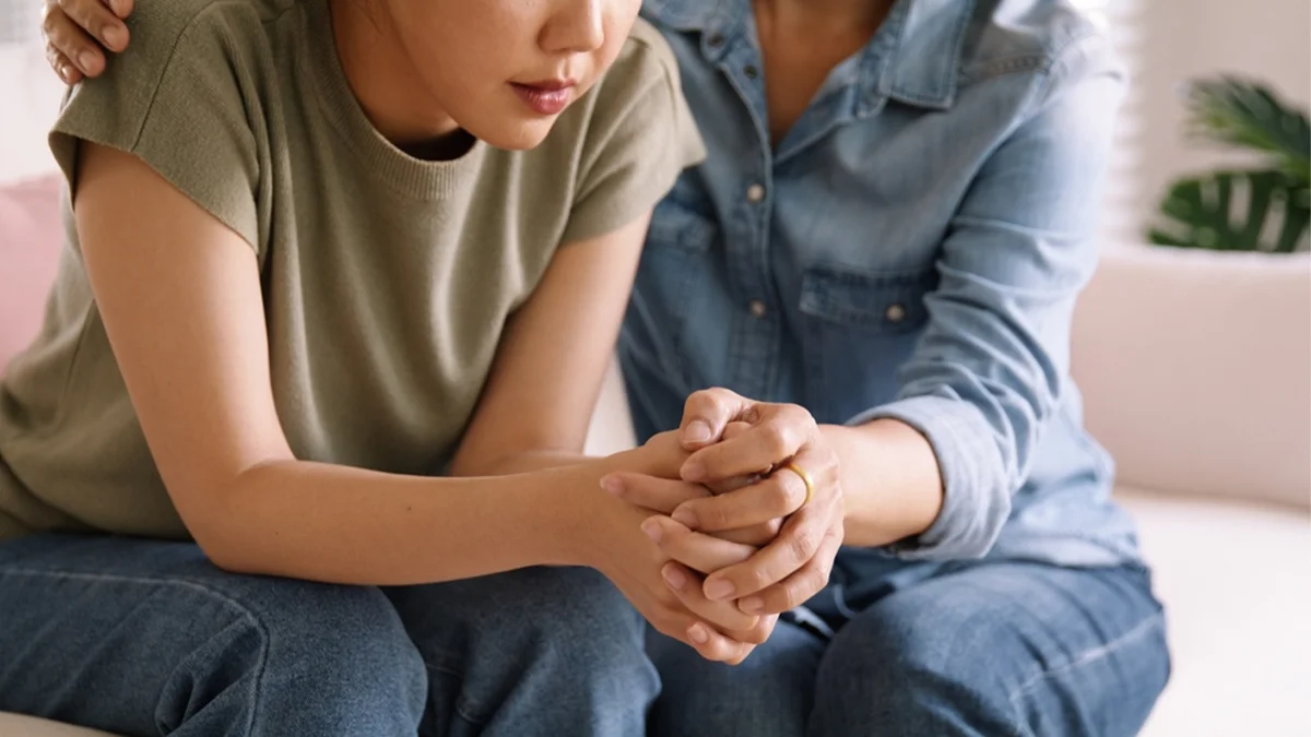 Closeup of a supportive hand hold. The stigma surrounding addiction in first responder communities can hinder recovery.